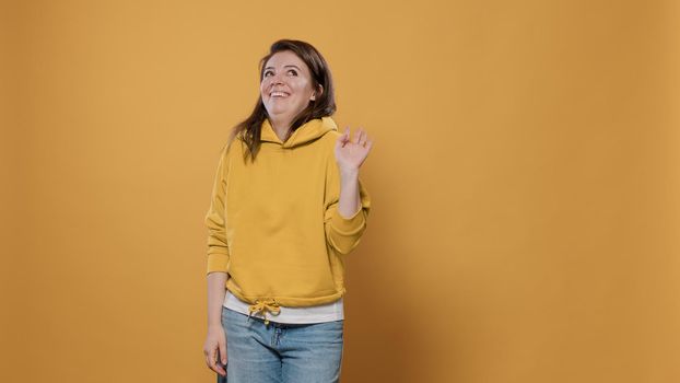 Young woman posing shy feeling embarrassed and awkward asking please stop with timid gesturing