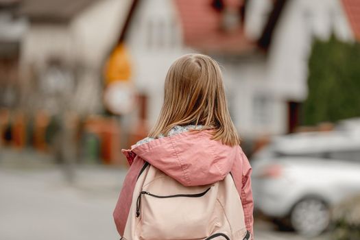 Schoolgirl walking at street