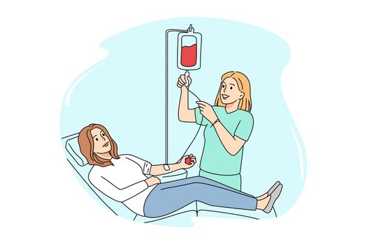 Female donor donate blood in clinic