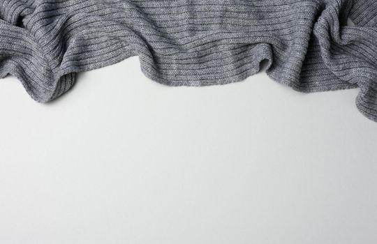gray knitted fabric on a gray background, top view