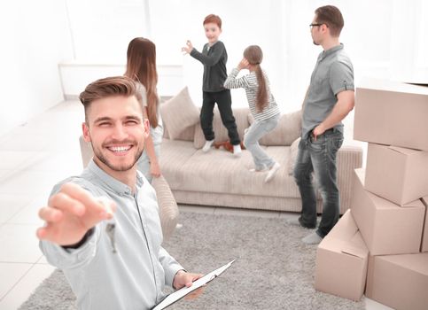 smiling realtor with clipboard showing keys to new apartment