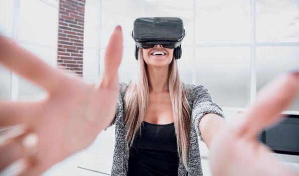 Young emotional woman wearing virtual reality goggles headset, vr box.
