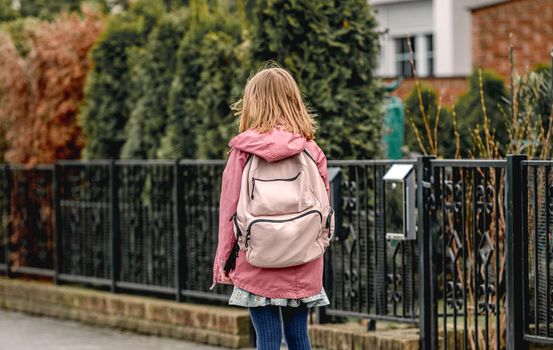 Schoolgirl walking at street