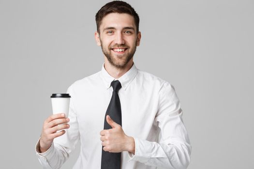 Portrait of a handsome businessman in formal suit with a cup of coffee.