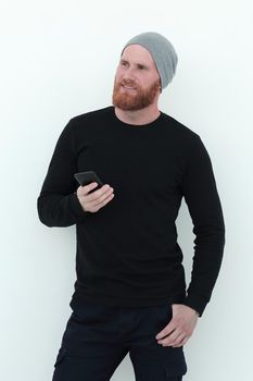 beautiful bearded man with smartphone looking at blank space