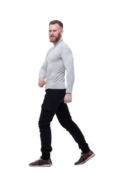 charismatic bearded man walks forward . isolated on white background