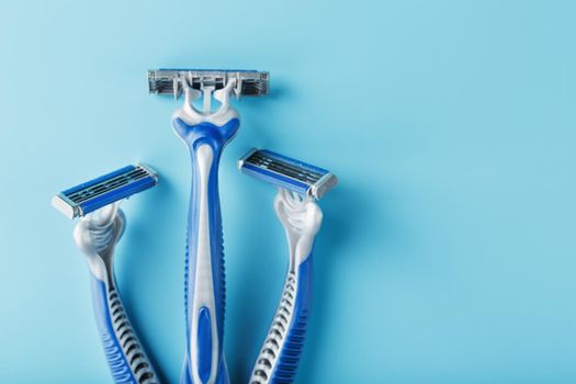 Blue shaving machines in a row on a blue background
