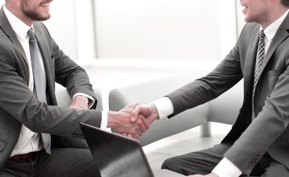 close up. businessman shaking hands with business partner
