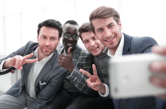 close up.a group of young employees takes a selfie