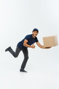 Delivery Concept - Handsome African American delivery man rush running for delivering a package for customer. Isolated on Grey studio Background. Copy Space.