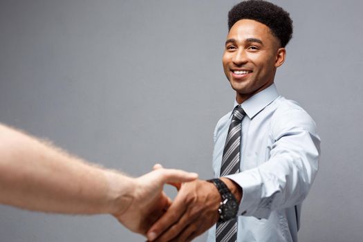Business concept - Close-up of two confident business people shaking hands during a meeting.
