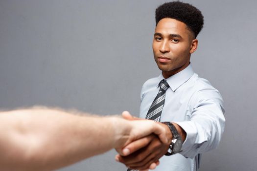 Business concept - Close-up of two confident business people shaking hands during a meeting.
