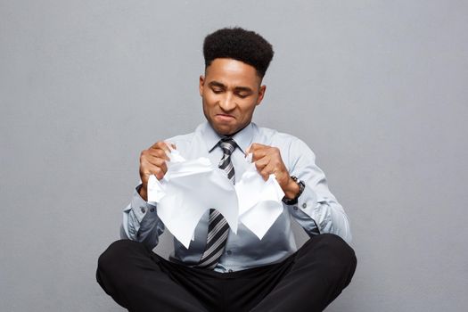 Business Concept - handsome young professional african american businessman throwing away pile of paperworks flying on air.