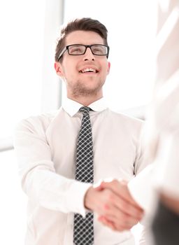 young businessman shakes hands with a business partner