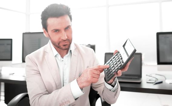 stylized photo.Businessman pointing to the calculator