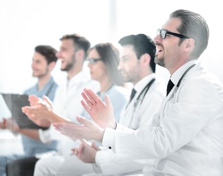 Medical team applauding in meeting