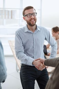 friendly business man shaking hands with his client