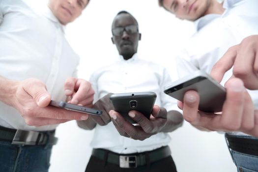 close up.three employees using their smartphones