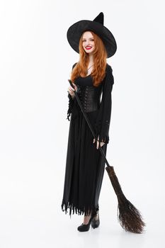 Halloween Witch Concept - Full-length Happy elegant witch with broomstick for celebrating halloween party over white background.