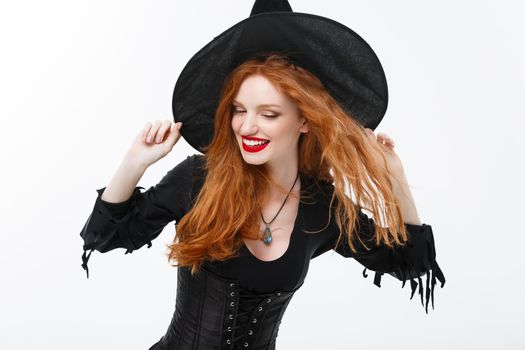Halloween witch concept - Happy Halloween ginger hair Witch. Isolated on white background.
