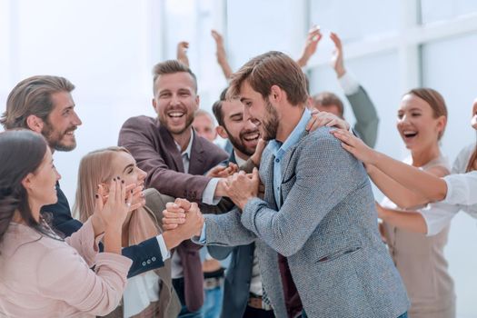 corporate group of employees applauding their colleague.