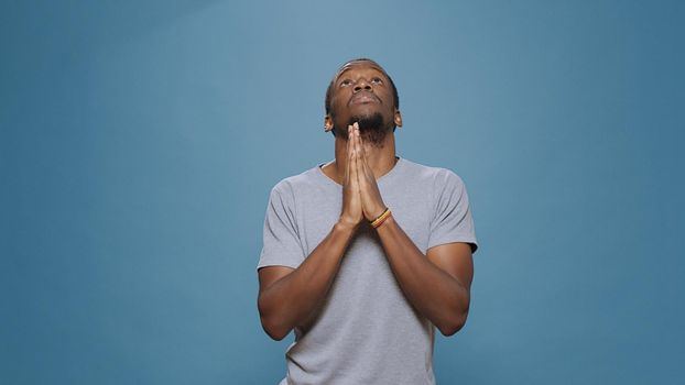 Male model holding hands in prayer to do spiritual session