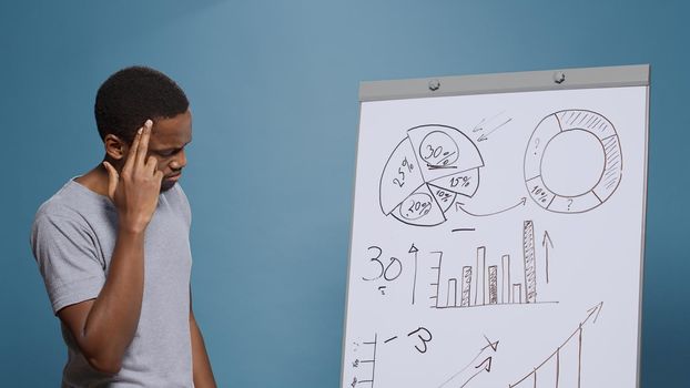 Company worker brainstorming ideas to create charts presentation
