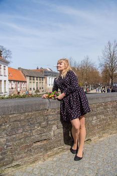 Bruges Belgium - April 23, 2022 girl with flowers. Selective focus.