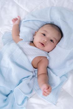 happy baby lying on a bed