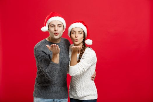 Christmas Concept - portrait lovely couple blowing wish to camera in Christmas day