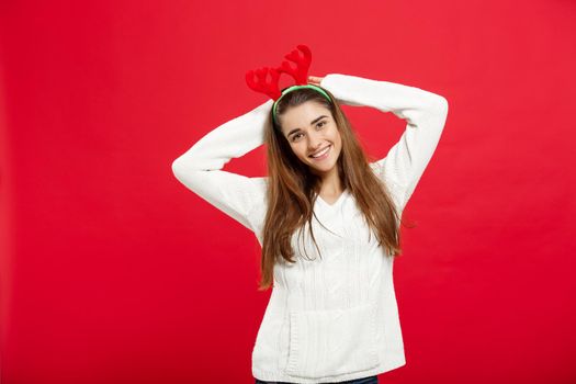 Christmas Concept - Young attractive caucasian lady wear reindeer hairband celebrating in Christmas day