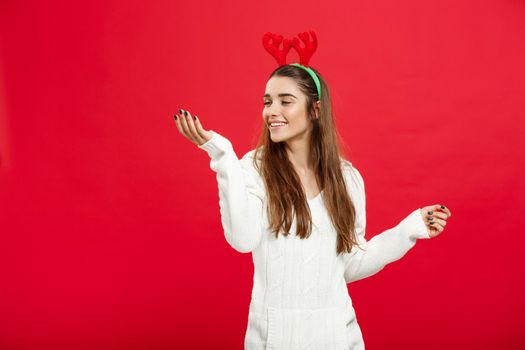 Christmas Concept - Young attractive caucasian lady wear reindeer hairband celebrating in Christmas day