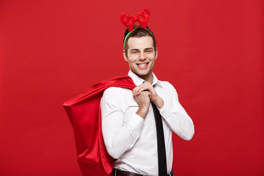 Christmas Concept - Handsome Business man celebrate merry christmas and happy new year wear reindeer hairband holding Santa red big bag.