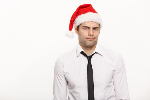 Christmas Concept - Handsome Business man wear santa hat posing with thoughtful facial expression on white isolated background.