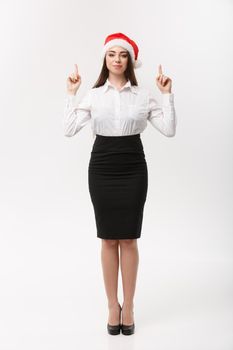 Business Concept - Modern caucasian business woman in the white studio background pointing finger upward presenting product.