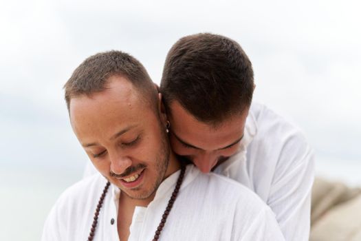 Close up photo of a gay couple in love embracing tenderness outdoors