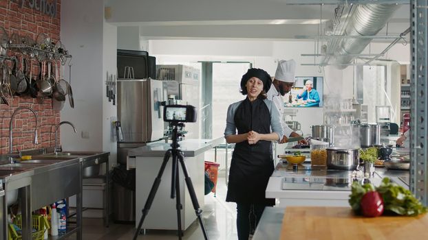 Authentic chef filming online cooking show in restaurant kitchen