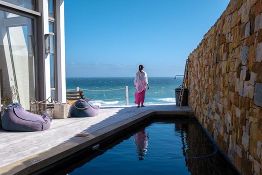 woman watching de ocean at a balcony De Hoop Nature reserve South Africa Western Cape, white dunes at the de hoop nature reserve which is part of the garden route
