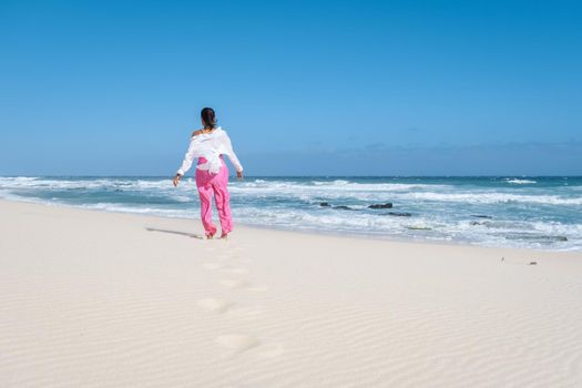 woman walking at the beach De Hoop Nature reserve South Africa Western Cape, Most beautiful beach of south africa with the white dunes at the de hoop nature reserve which is part of the garden route