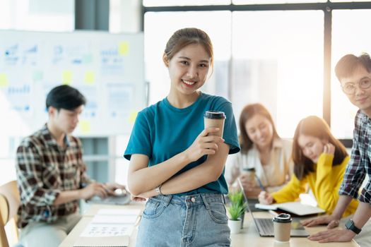 Group of asian young creative happy enjoy laugh smile and great success emotion teamwork people business startup entrepreneur casual brainstorm business meeting office background