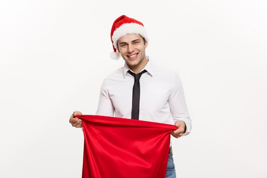 Christmas Concept - Handsome Business man celebrate merry christmas and happy new year wear santa hat with Santa red big bag.