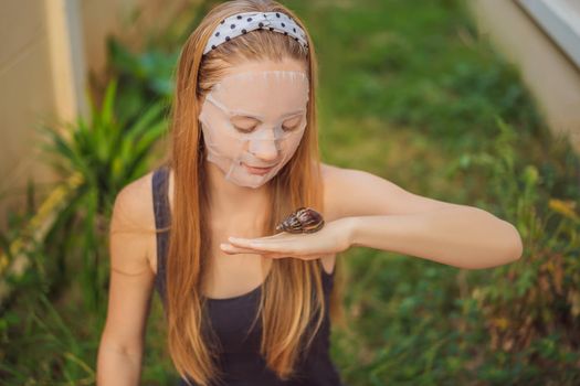 A young woman makes a face mask with snail mucus. Snail crawling on a face mask
