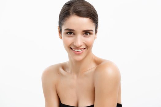 Health care and spa concept - attractive young and healthy woman with nude makeup on white background.