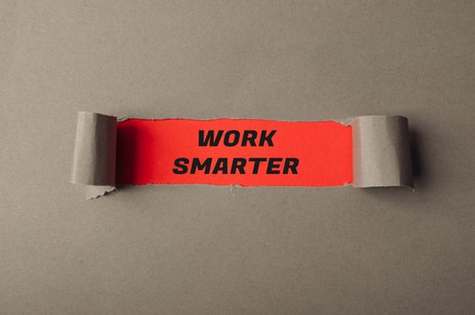 Phrase Work Smarter on red background in torn grey paper
