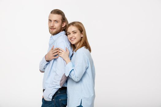 young attractive couple in blue shirt showing engaged ring.