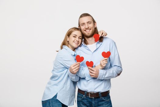 Couple in love holding red paper hearts