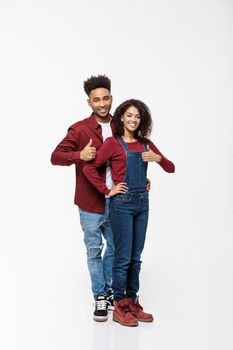 Lovely African American couple gesturing thumbs up to camera.
