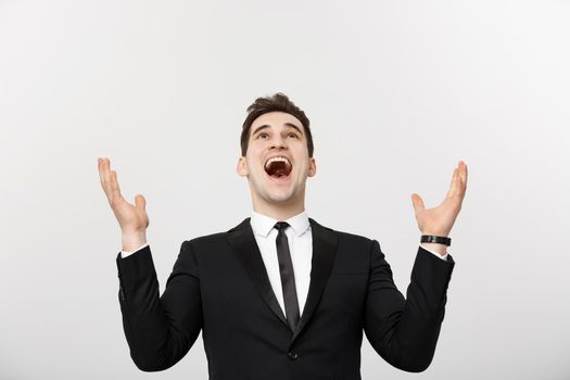 Business Concept: Excited handsome businessman celebration success. Isolated on white.