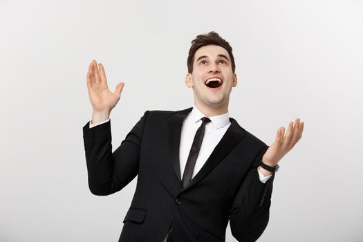 Business Concept: Excited handsome businessman celebration success. Isolated on white.