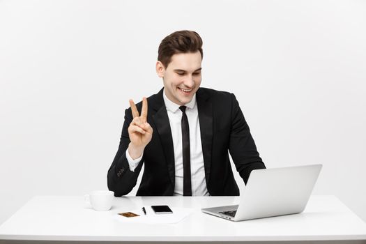 Young businessman facetime with someone and showing two finger or victory finger sign